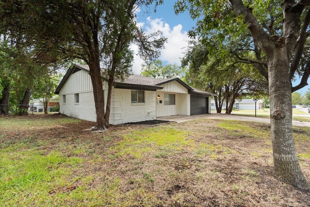 single story home featuring a front lawn and a garage