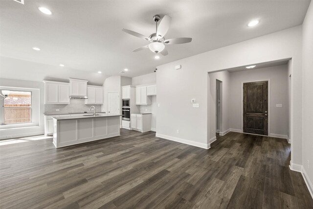 kitchen with visible vents, white cabinets, vaulted ceiling, stainless steel appliances, and a sink