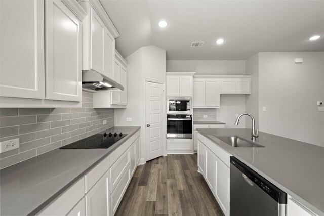 full bath featuring tile patterned flooring, two vanities, vaulted ceiling, and a sink