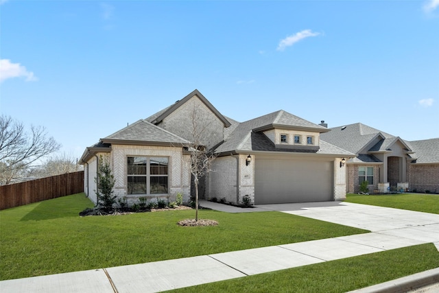 view of front of house featuring driveway, brick siding, a front yard, and fence