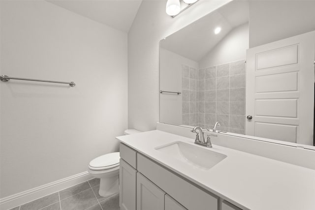 bathroom with baseboards, toilet, tile patterned flooring, vaulted ceiling, and vanity