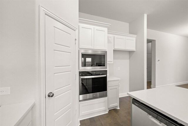 kitchen featuring stainless steel microwave, wall oven, a sink, under cabinet range hood, and black electric cooktop