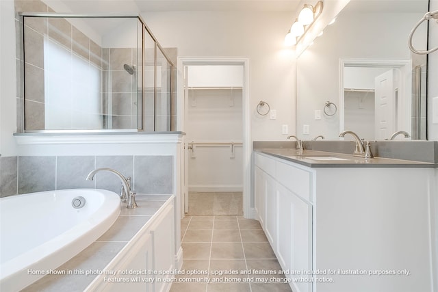 bathroom with tile patterned flooring, vanity, and independent shower and bath