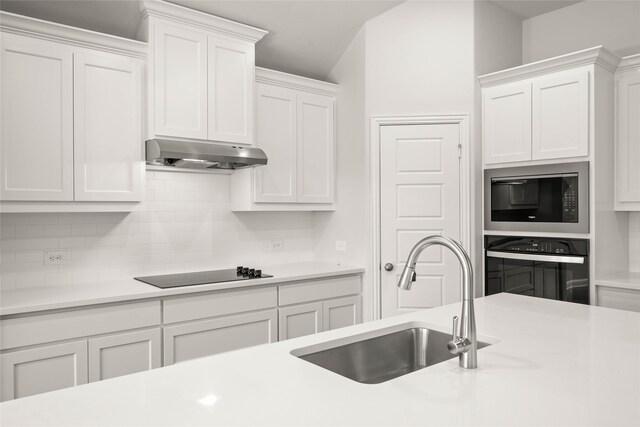 kitchen with stainless steel appliances, dark wood-type flooring, baseboards, white cabinets, and light countertops