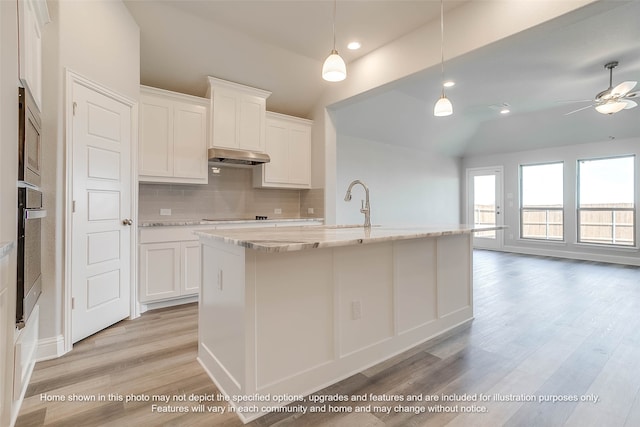 kitchen featuring white cabinetry, appliances with stainless steel finishes, decorative light fixtures, and sink