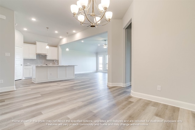 interior space with sink, ceiling fan with notable chandelier, and light wood-type flooring