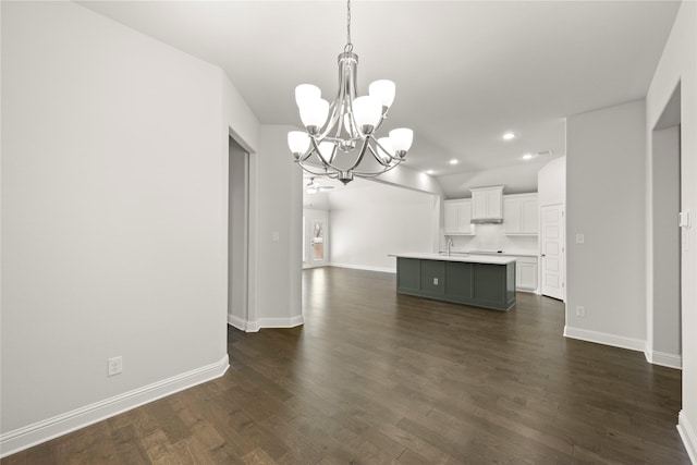 unfurnished living room with recessed lighting, dark wood-style flooring, a sink, and baseboards