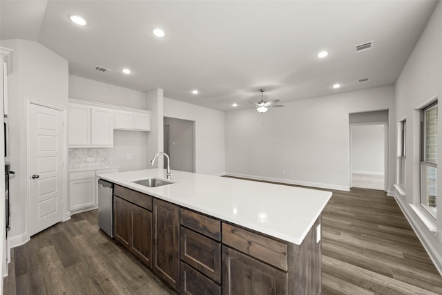 kitchen with a center island with sink, a sink, dark wood finished floors, white cabinetry, and dishwasher