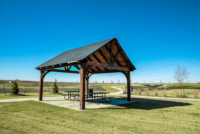 view of property's community featuring a gazebo, a yard, and a rural view