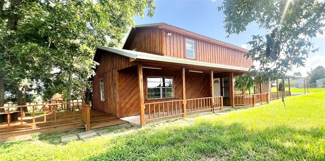 exterior space with a front lawn and a wooden deck