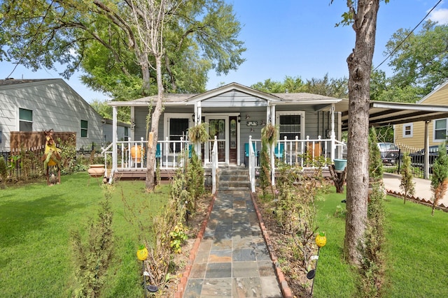 view of front of home featuring a front yard, a carport, and a porch