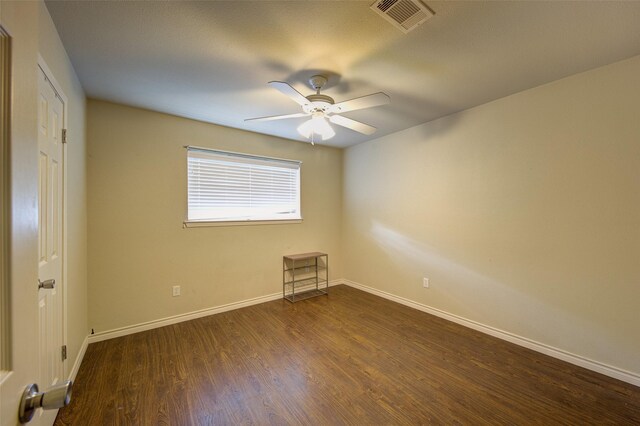 empty room featuring ceiling fan and dark hardwood / wood-style flooring