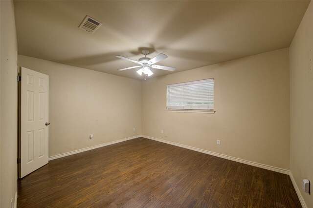 empty room featuring ceiling fan and dark hardwood / wood-style flooring