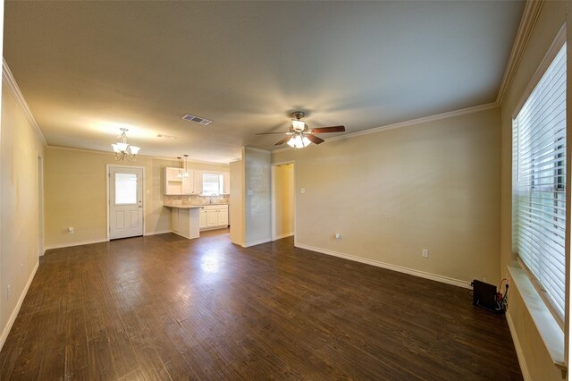 unfurnished living room with ceiling fan with notable chandelier, dark hardwood / wood-style floors, and crown molding