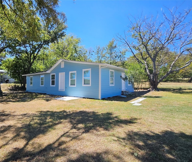 view of side of property featuring a yard