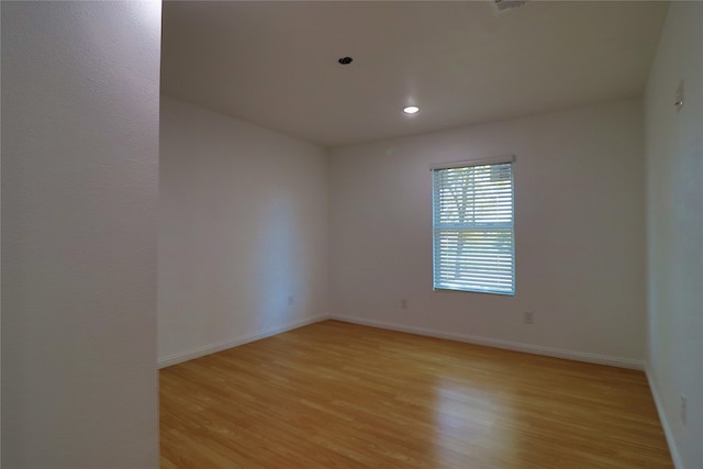 spare room featuring light wood-type flooring