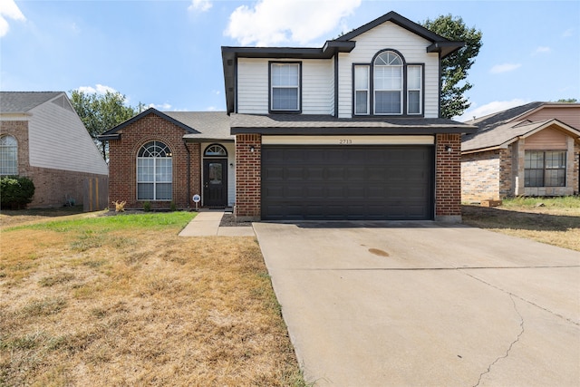 front of property with a garage and a front lawn