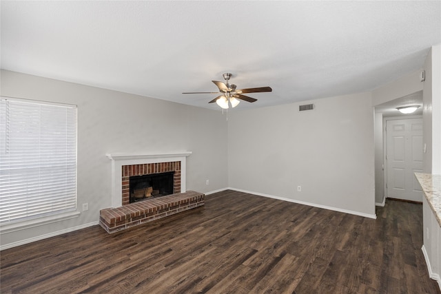 unfurnished living room featuring dark wood-type flooring, ceiling fan, and a fireplace