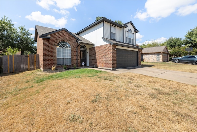 view of property featuring a garage and a front yard