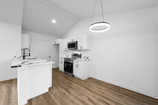 kitchen featuring appliances with stainless steel finishes, white cabinetry, sink, and vaulted ceiling with beams