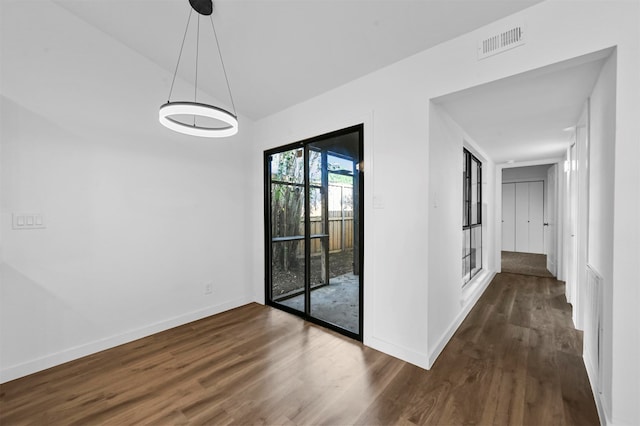 spare room featuring dark wood-type flooring