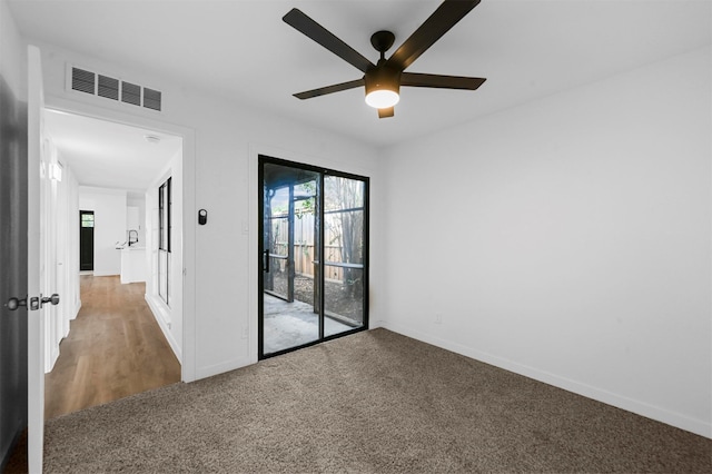 carpeted empty room with ceiling fan