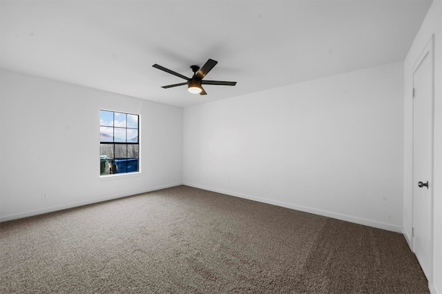 spare room featuring ceiling fan and carpet floors