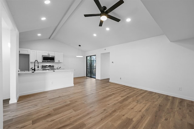 unfurnished living room with beam ceiling, sink, high vaulted ceiling, hardwood / wood-style flooring, and ceiling fan