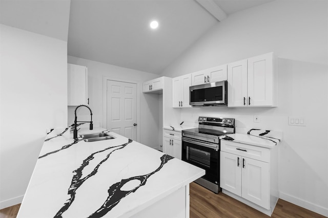 kitchen with white cabinetry, sink, dark wood-type flooring, appliances with stainless steel finishes, and lofted ceiling