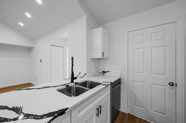 kitchen featuring dark wood-type flooring, white cabinetry, sink, and stainless steel dishwasher