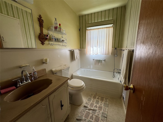 bathroom featuring tile patterned flooring, toilet, and vanity