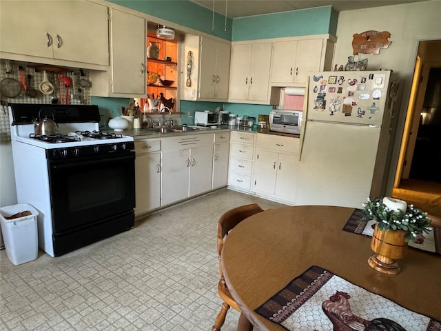 kitchen featuring white appliances and sink