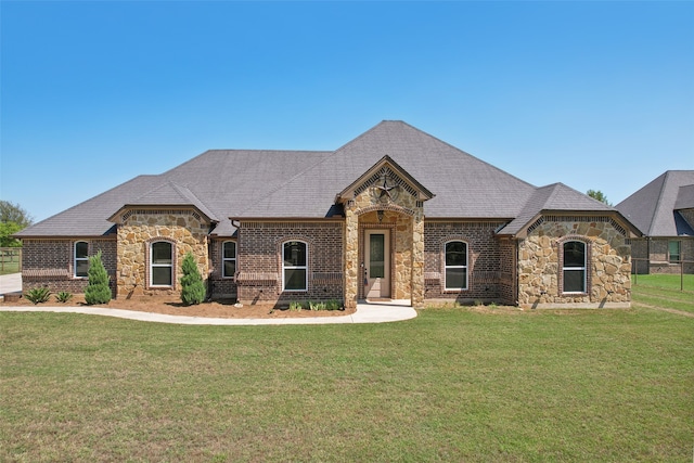 french country home featuring a front lawn