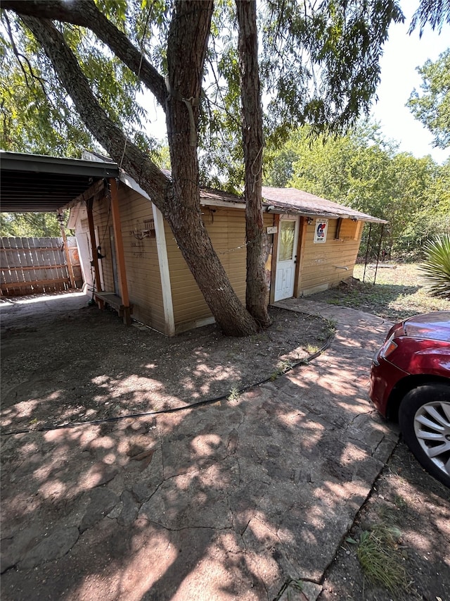 view of side of property featuring a carport