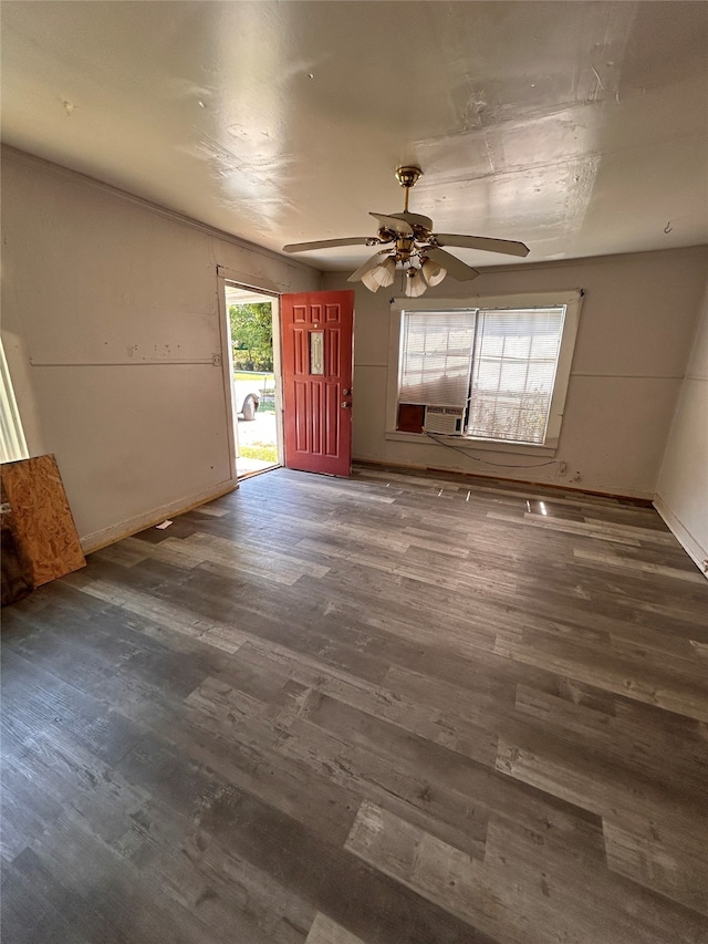 unfurnished living room with cooling unit, ceiling fan, and dark hardwood / wood-style floors