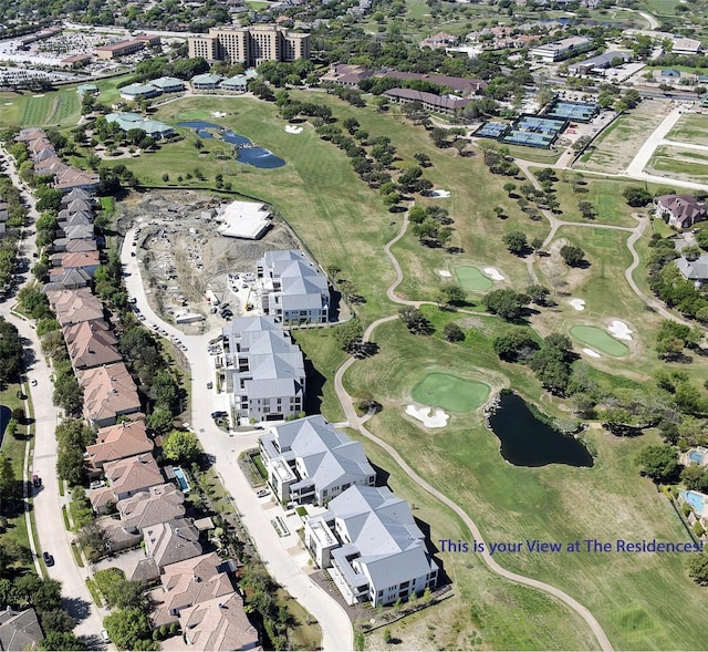 birds eye view of property with view of golf course, a water view, and a residential view