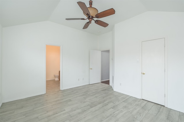 unfurnished bedroom featuring lofted ceiling, ceiling fan, light hardwood / wood-style floors, and ensuite bath