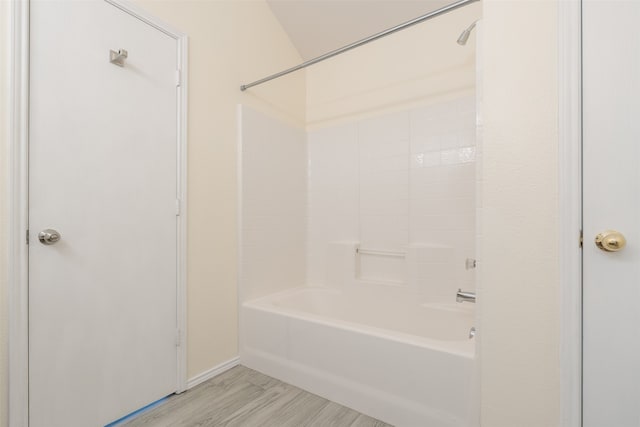 bathroom with shower / tub combination and wood-type flooring