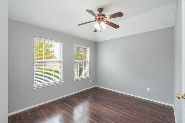 spare room featuring dark wood-type flooring and ceiling fan