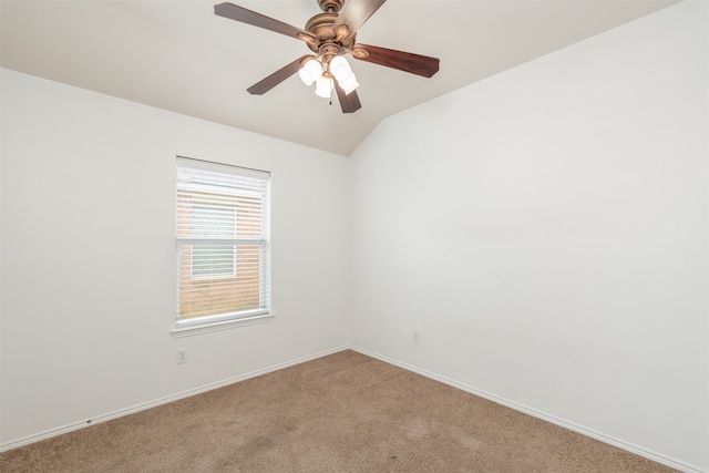 carpeted spare room with vaulted ceiling and ceiling fan