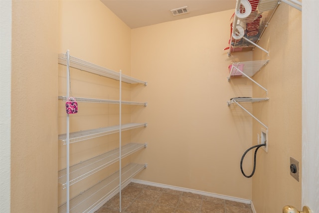 spacious closet with light tile patterned flooring