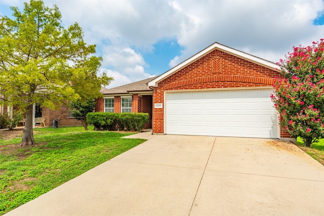 view of front of house with a front yard and a garage