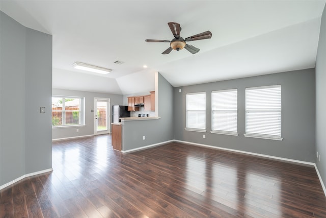 unfurnished living room featuring lofted ceiling, ceiling fan, and dark wood-type flooring