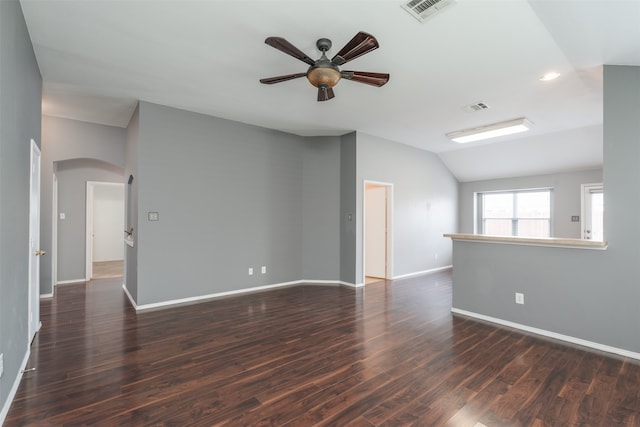 empty room featuring lofted ceiling, ceiling fan, and dark hardwood / wood-style floors