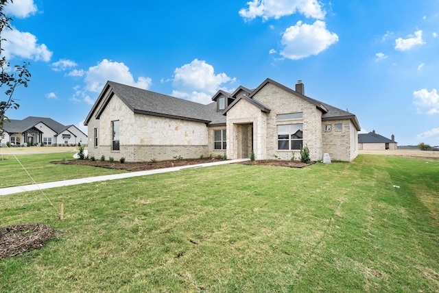 french country style house featuring a front lawn