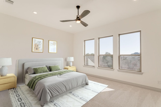 bedroom featuring ceiling fan and light colored carpet