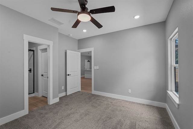 unfurnished bedroom featuring ceiling fan and carpet