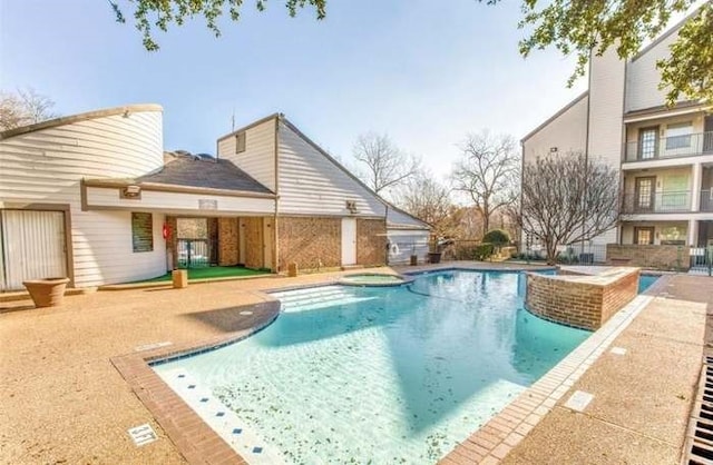 view of swimming pool with a patio