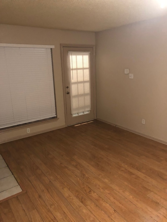 unfurnished room with light hardwood / wood-style flooring