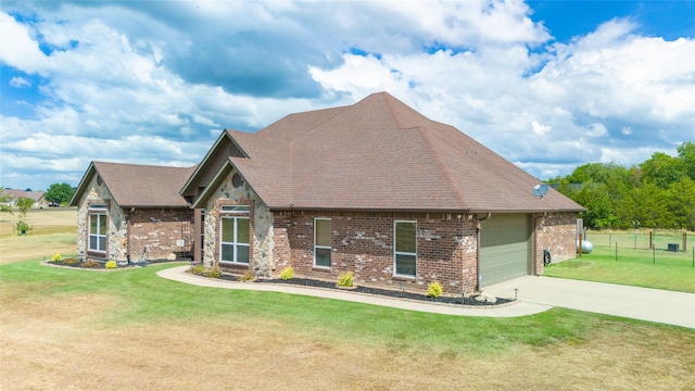 view of front of house with a front yard and a garage